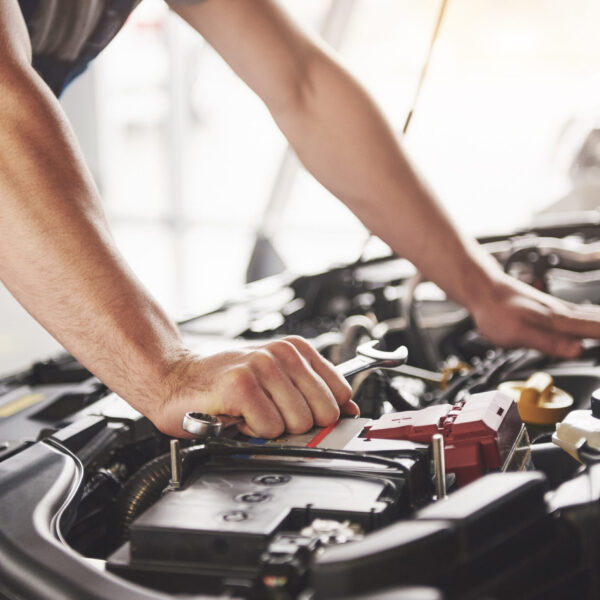 Auto mechanic working garage repair service scaled 1 600x600